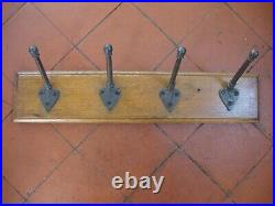 Antique original cast iron coat rack hooks on reclaimed oak board